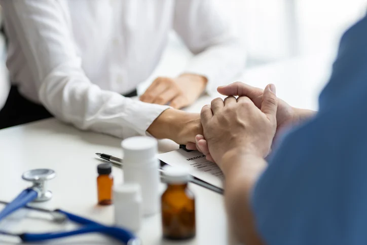 Medicine and healthcare concepts. Doctor holding patient's hand and comforting psychiatrist patient.